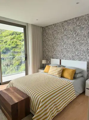 a bedroom with a bed and a large window at Cardais Paradise View in São Vicente