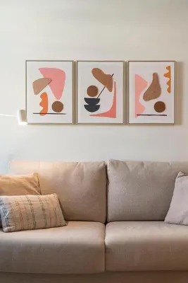 four pictures hanging on a wall above a couch at Infante Funchal Centrum in Funchal