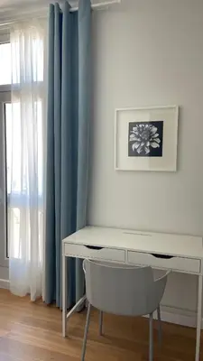 a white desk with a chair in front of a window at Infante Funchal Centrum in Funchal