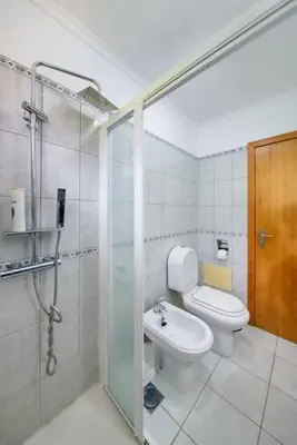 a bathroom with a toilet and a shower and a sink at Gabriel Loft by MTH in Ponta do Sol