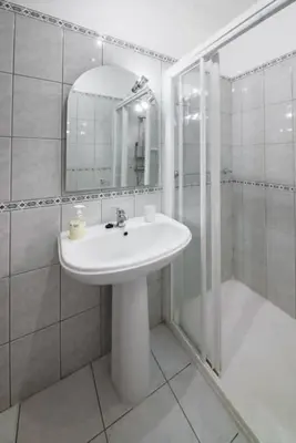 a white bathroom with a sink and a shower at Gabriel Loft by MTH in Ponta do Sol