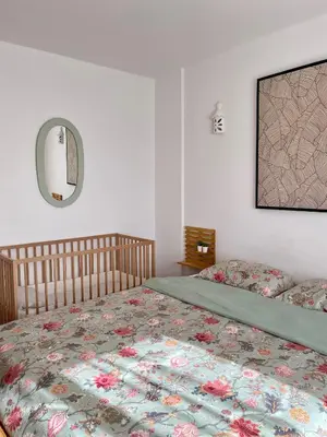 a bedroom with a bed and a mirror on the wall at Casa Luz in Luz