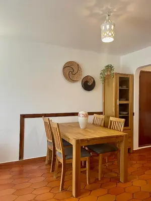a dining room with a wooden table and chairs at Casa Luz in Luz