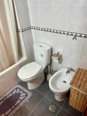 a bathroom with a toilet and a sink at Casa Luz in Luz