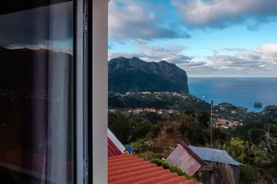 a view of the ocean and a mountain from a window at GuestReady - Delight Getaway in Madeira in Machico