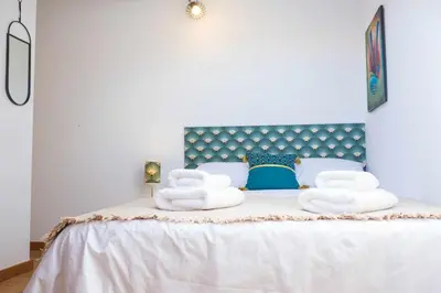 a bedroom with a bed with towels on it at Rosalina's Apartment in Caniço
