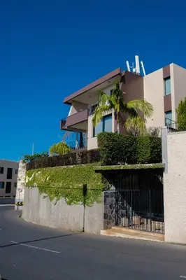 a house with ivy on the side of a street at GuestReady - Funchal Sunny Retreat in Funchal