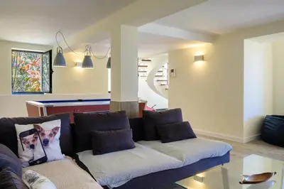 a living room with a couch with a dog on the pillow at GuestReady - Funchal Sunny Retreat in Funchal