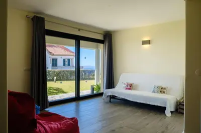 a living room with a white couch and a large window at GuestReady - Funchal Sunny Retreat in Funchal