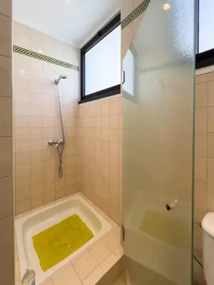 a bathroom with a shower and a tub with a window at GuestReady - Funchal Sunny Retreat in Funchal