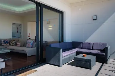 a living room with a purple couch and a table at GuestReady - Funchal Sunny Retreat in Funchal