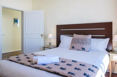 a bedroom with a large bed with a brown headboard at GuestReady - Funchal Sunny Retreat in Funchal