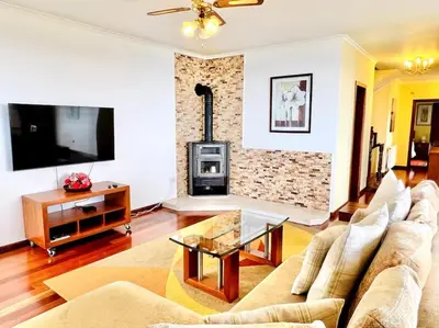 a bedroom with a bed and a ceiling fan at Casa Amarela by Your Madeira Rentals in Ponta do Sol