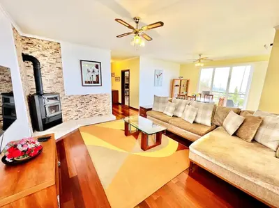 a living room with a couch and a fireplace at Casa Amarela by Your Madeira Rentals in Ponta do Sol