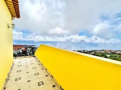 a yellow wall on top of a building at Casa Amarela by Your Madeira Rentals in Ponta do Sol