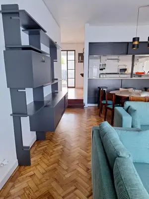 a living room with a couch and a kitchen at Casa da Avó Teresa in Porto Santo