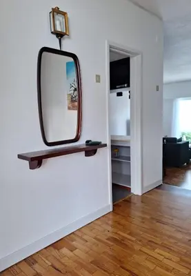 a mirror on a wall in a living room at Casa da Avó Teresa in Porto Santo