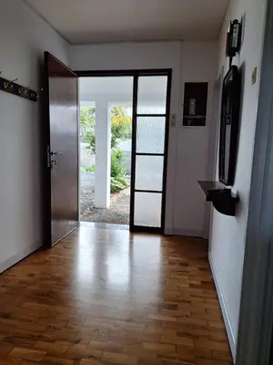 an empty hallway with a door and a wooden floor at Casa da Avó Teresa in Porto Santo