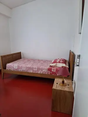 a bedroom with a bed and a table with a lamp at Casa da Avó Teresa in Porto Santo