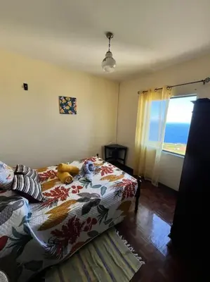 a bedroom with a bed with a teddy bear on it at El Atardecer del Norte in Salão