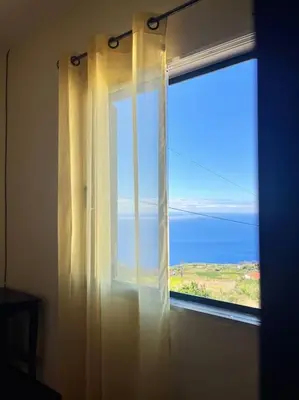 a window with a view of the ocean at El Atardecer del Norte in Salão