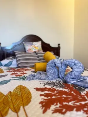 a bed with a pile of blankets on it at El Atardecer del Norte in Salão