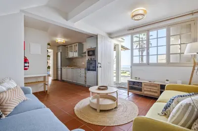 a living room with a blue couch and a table at Hilani House by Homie in São Vicente