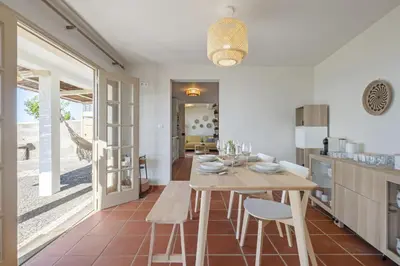 a kitchen and dining room with a table and chairs at Hilani House by Homie in São Vicente