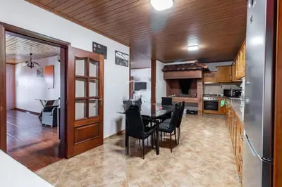 a kitchen and dining room with a table and chairs at Peaceful retreat near Levadas in Arco da Calheta