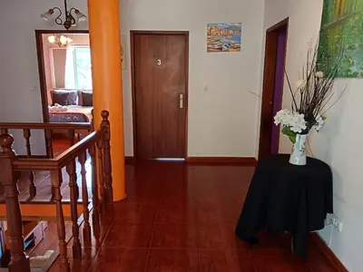 a hallway with a table with a vase of flowers on it at Peaceful retreat near Levadas in Arco da Calheta