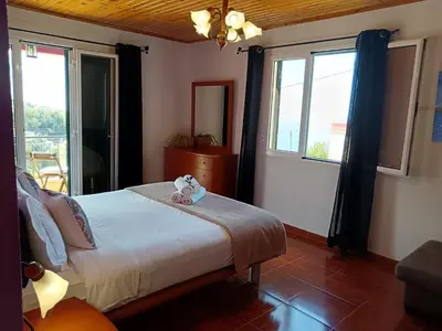 a bedroom with a bed with a teddy bear on it at Peaceful retreat near Levadas in Arco da Calheta