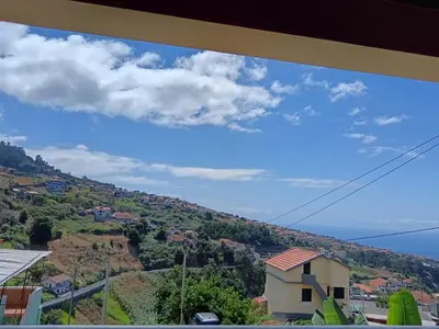 a view of a hill with a house on it at Casa Central - Peceful Mountain Retreat in Calheta in Arco da Calheta