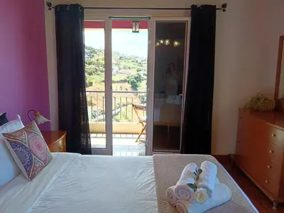 a bedroom with a bed with towels on it at Casa Central - Peceful Mountain Retreat in Calheta in Arco da Calheta