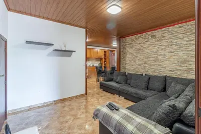a living room with a couch and a brick wall at Casa Central - Peceful Mountain Retreat in Calheta in Arco da Calheta
