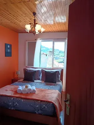 a bedroom with a bed with two towels on it at Casa Central - Peceful Mountain Retreat in Calheta in Arco da Calheta