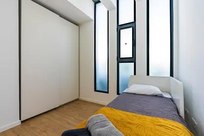 a bedroom with a bed and two windows at Casa Branca-A, beautiful sea view in Estreito da Calheta