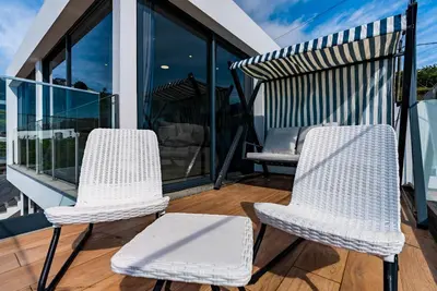 two chairs and a table on a balcony at Casa Branca-A, beautiful sea view in Estreito da Calheta