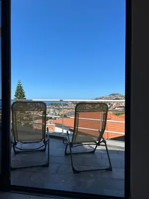 two chairs sitting on a balcony with a view at Funchal Casa in Funchal
