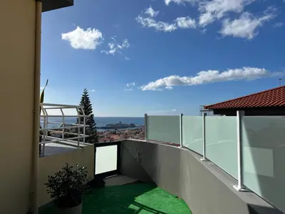 a balcony of a house with green grass at Funchal Casa in Funchal