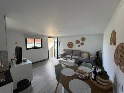 a living room with a table and a couch at Funchal Casa in Funchal