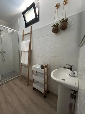 a bathroom with a sink and a shower at Funchal Casa in Funchal