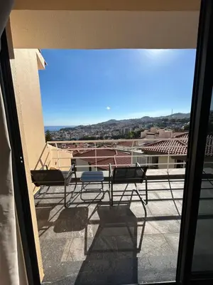 a patio with a table and chairs on a balcony at Funchal Casa 2 in Funchal