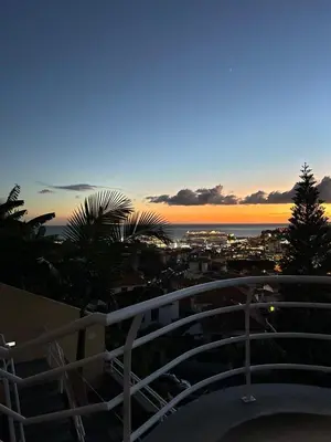 a view of the ocean from a balcony at sunset at Funchal Casa 2 in Funchal