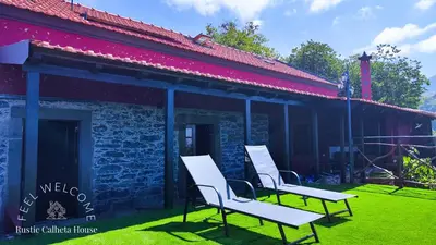 a group of chairs sitting outside of a building at Rustic Calheta House in Arco da Calheta