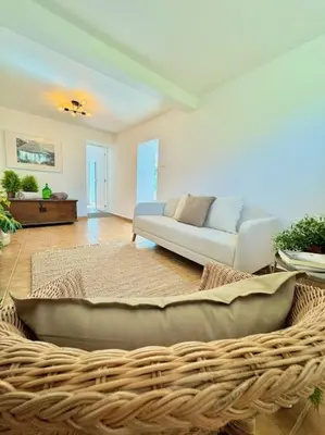 a living room with a couch and a wicker basket at Casa Juliana in Ribeira Brava