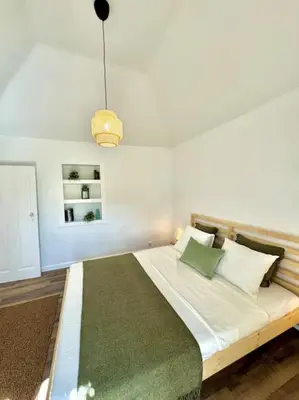 a bedroom with a large bed with green pillows at Casa Juliana in Ribeira Brava