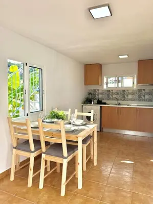 a kitchen with a table and chairs in a room at Casa Juliana in Ribeira Brava