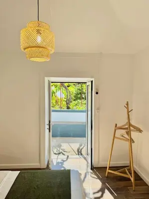 a room with a door with a window and a ladder at Casa Juliana in Ribeira Brava