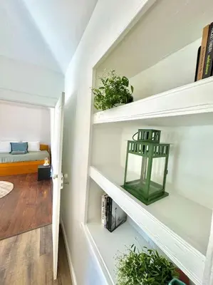 a room with shelves with plants and a bed at Casa Juliana in Ribeira Brava