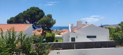 a white house on a hill with trees at Casa Bambi in Porto Santo